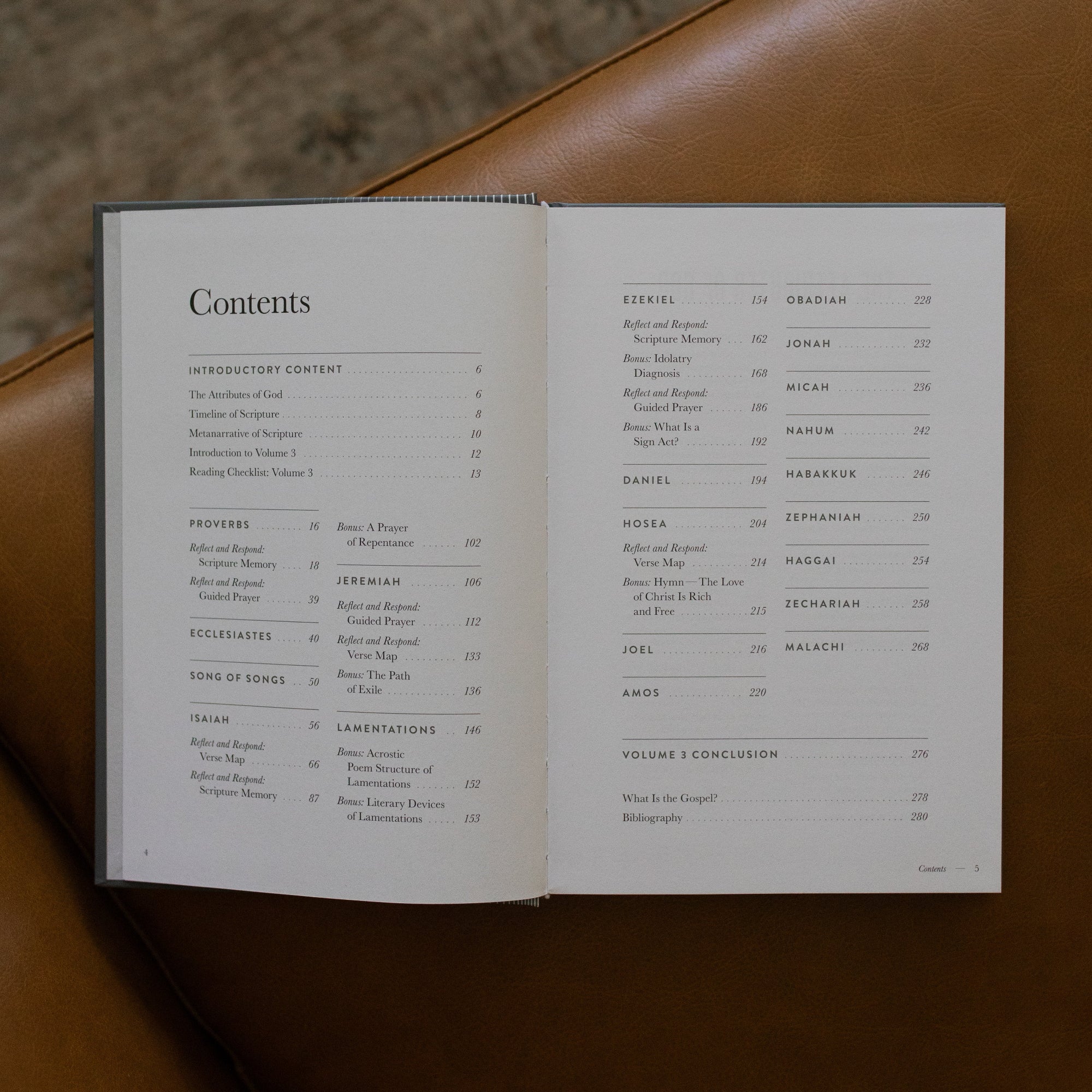 A Year in the bible Vol 3 opened to the table of contents page on a leather couch