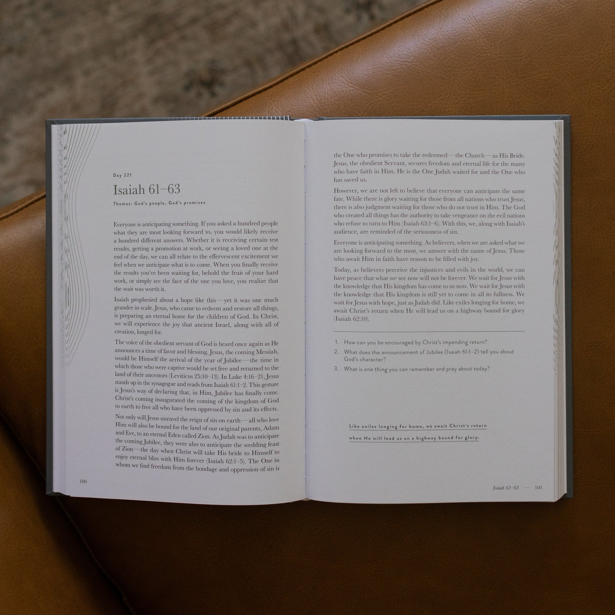 A Year in the bible Vol 3 opened to the Isaiah beginning page on a leather couch