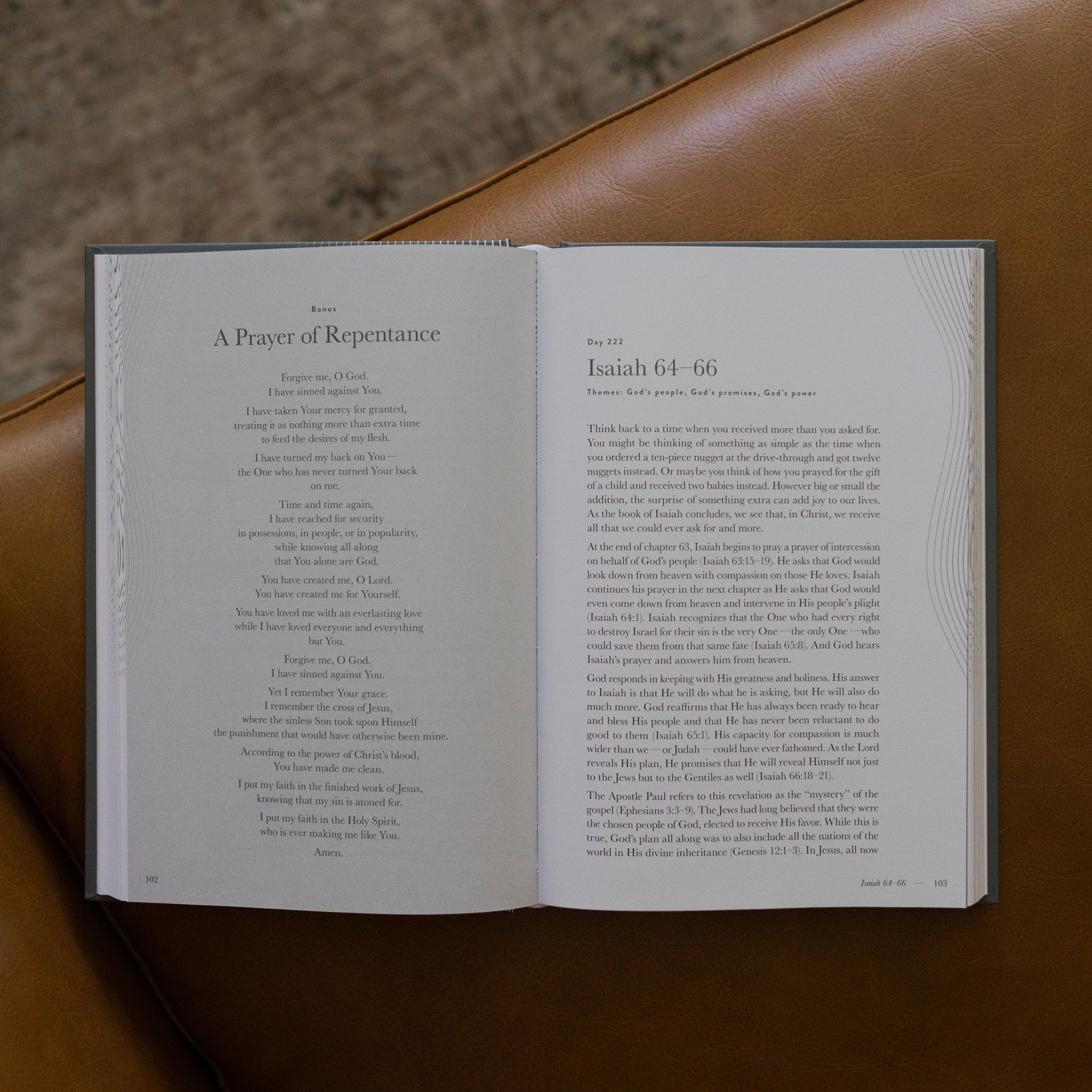 A Year in the bible Vol 3 opened to the Isaiah 64 beginning page on a leather couch