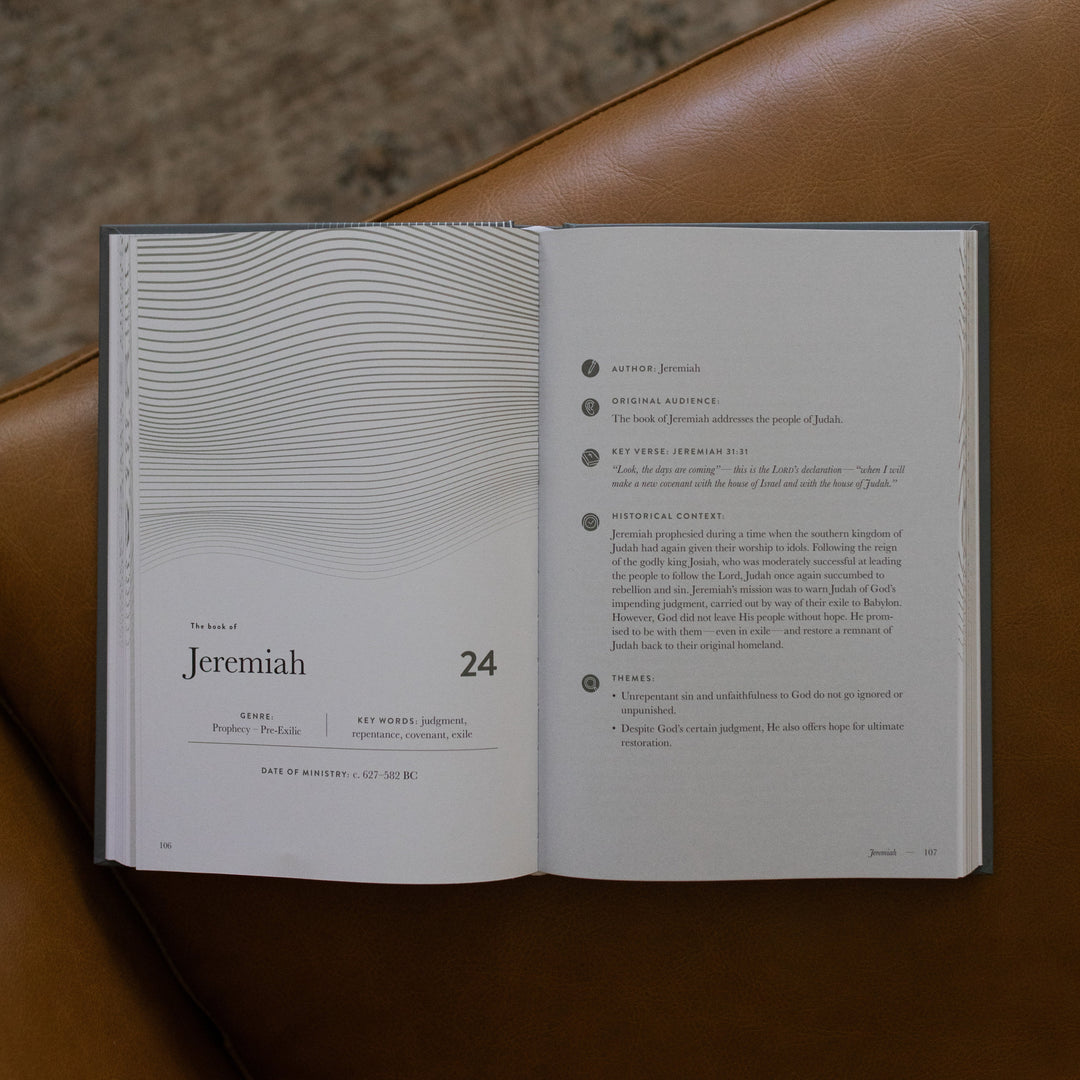 A Year in the bible Vol 3 opened to the Jeremiah beginning page on a leather couch