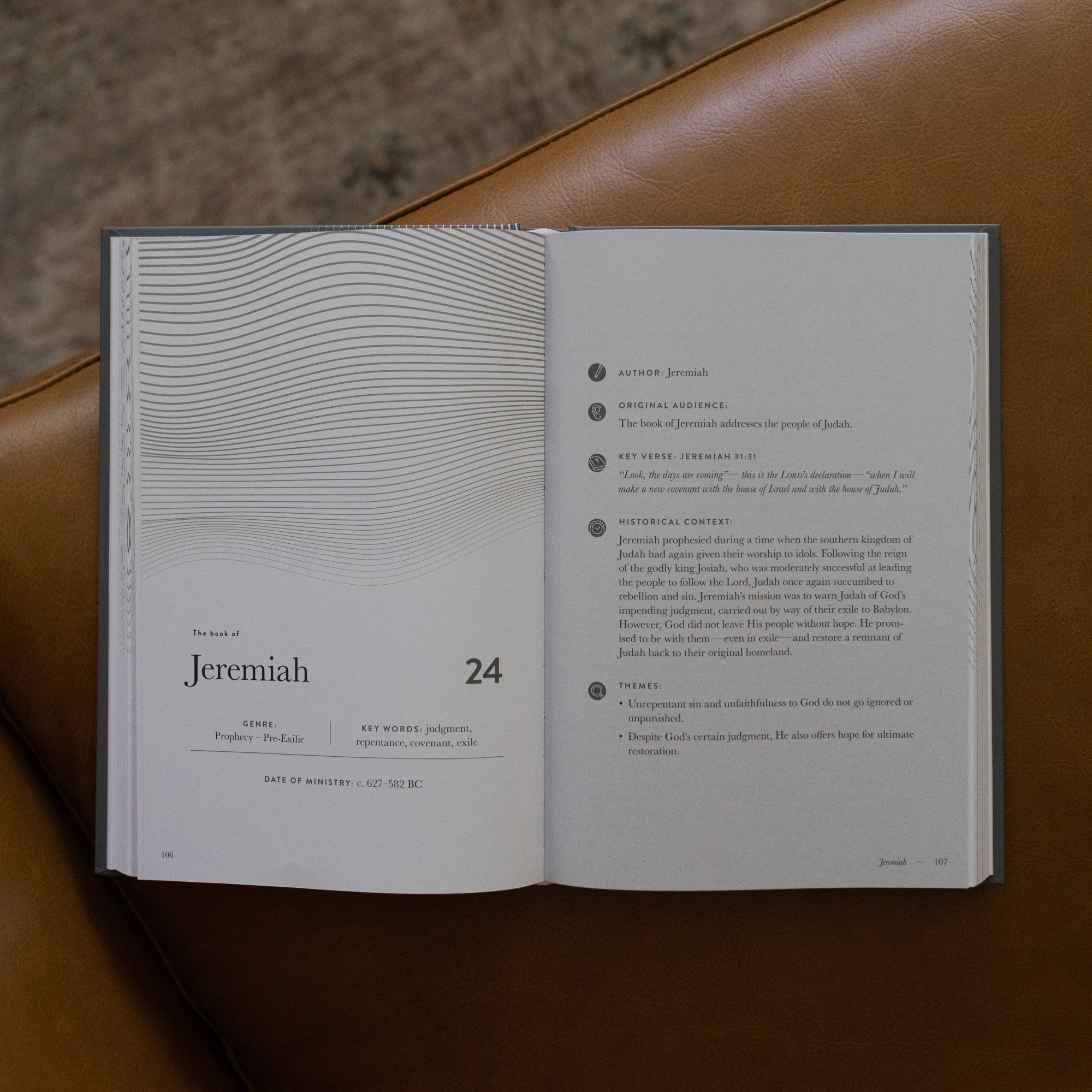 A Year in the bible Vol 3 opened to the Jeremiah beginning page on a leather couch