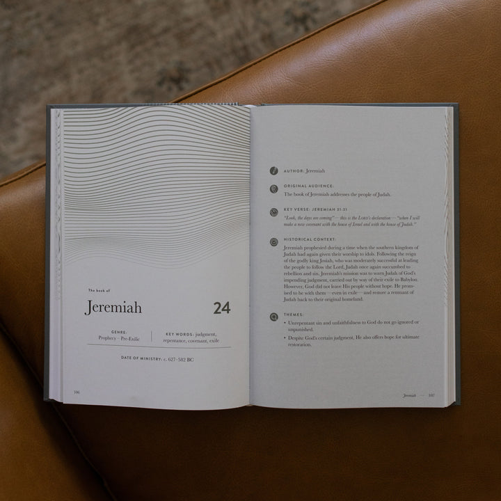 A Year in the bible Vol 3 opened to the Jeremiah beginning page on a leather couch