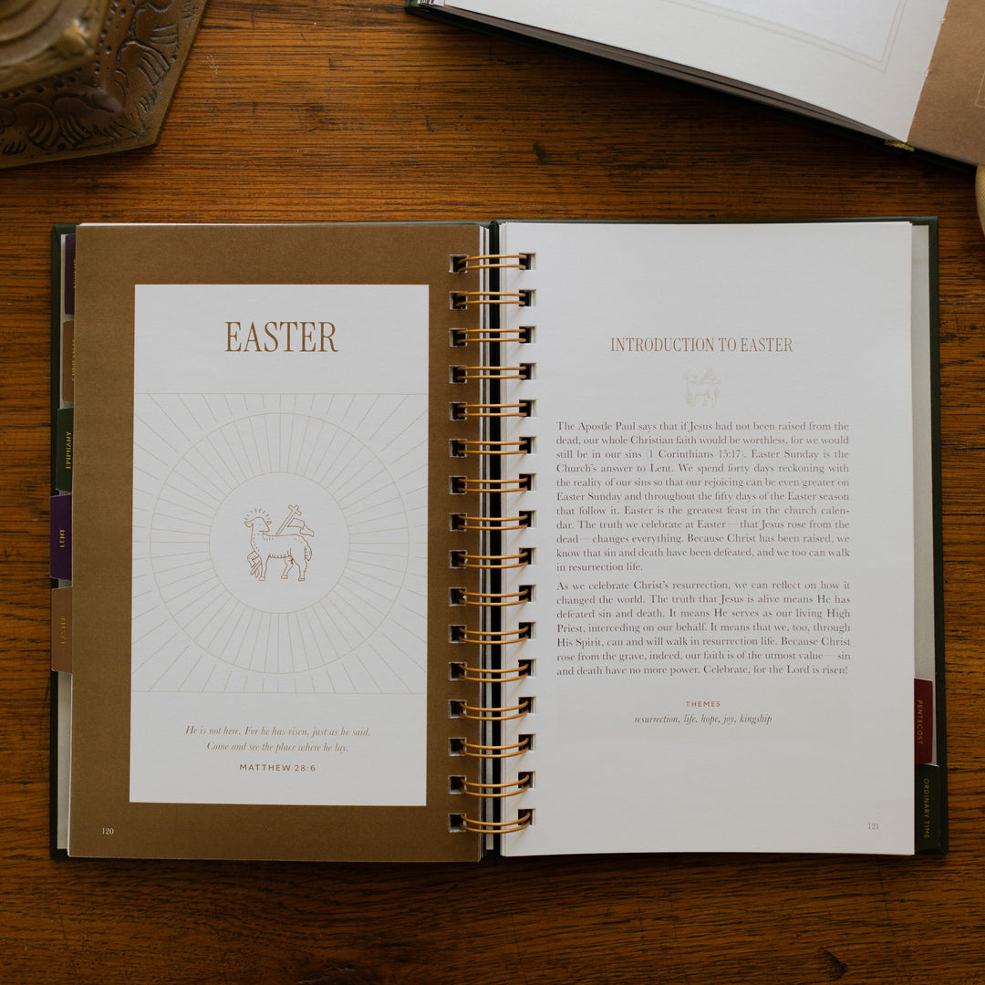 A Year of Liturgical Living opened to the Easter section on a wooden table next to a bronze colored candlestick