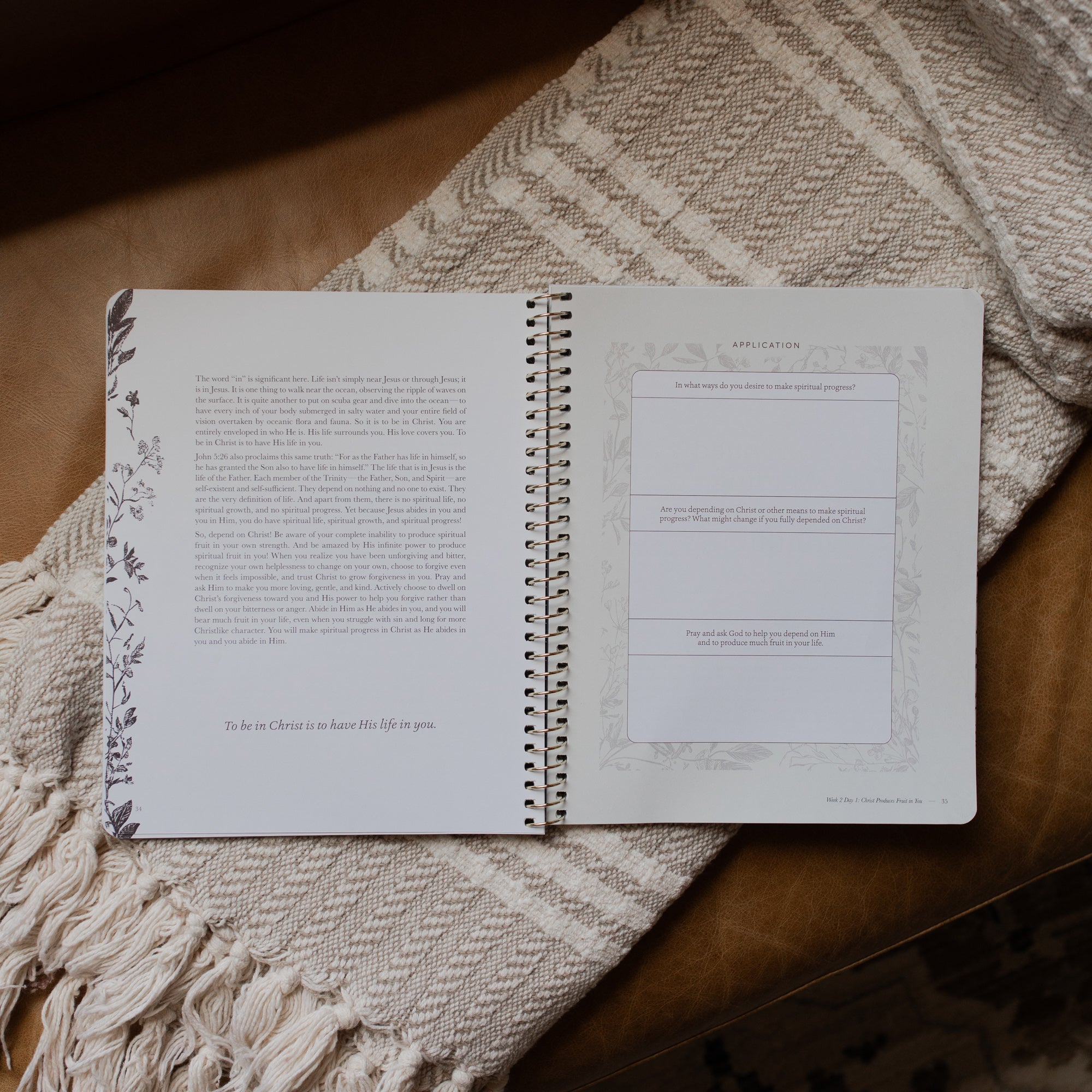 The Abide Spiral opened to the Applications page on a cream colored blanket