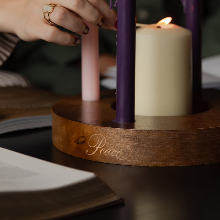 Up close of a candle ring with the word Peace etched on the side of it