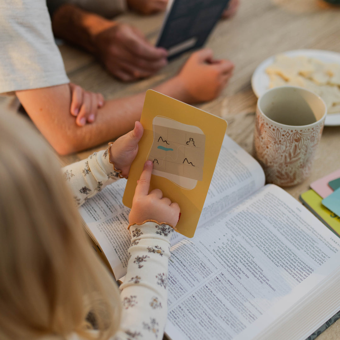 Little girl pointing to illustration on Advent Cards for Little Hearts