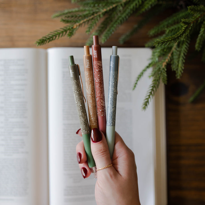 Hand holding all 4 Advent Pens