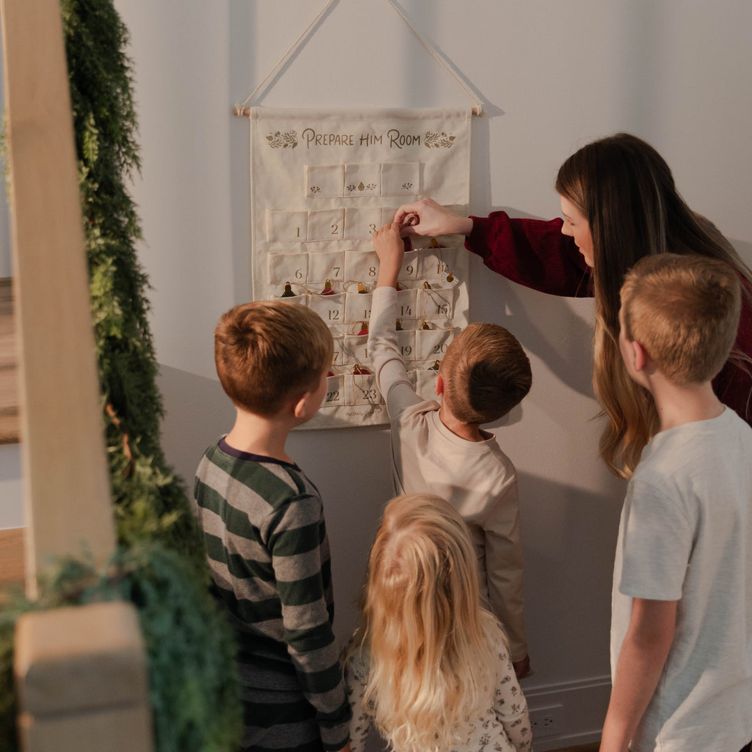 Family putting in ornaments for Advent Wall Calendar