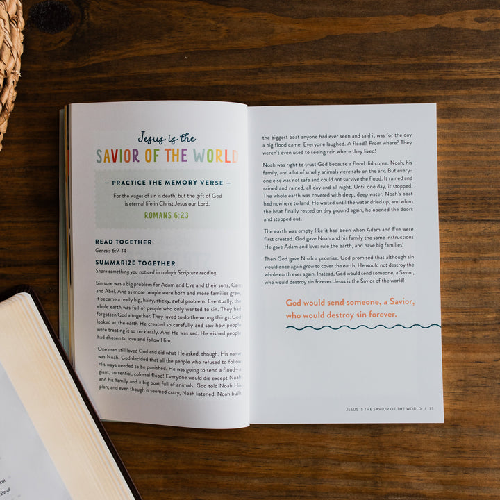 Open children's devotional on a wooden surface with text and colorful headings.