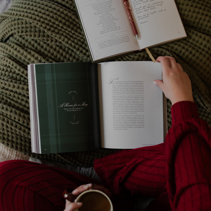 A woman reading the Awakening Wonder Memory verse with a cup of coffee in her other hand