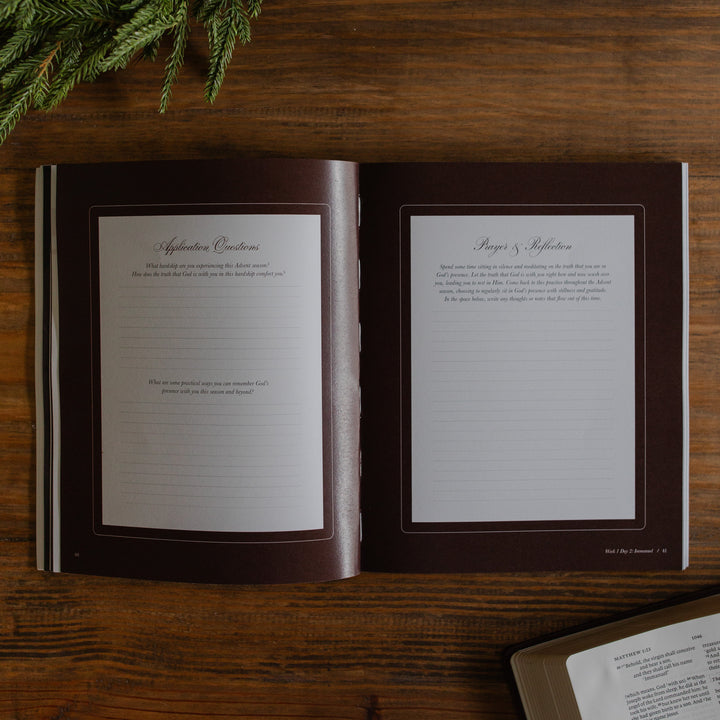 The Awakening Wonder opened to the Questions and Reflection page on a wooden table