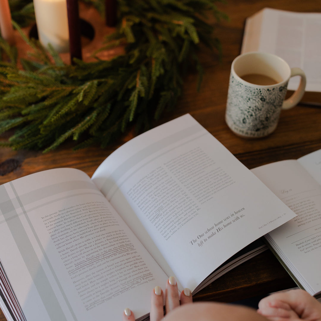 The Awakening Wonder study open on a wooden table next to some greenery and a coffee cup