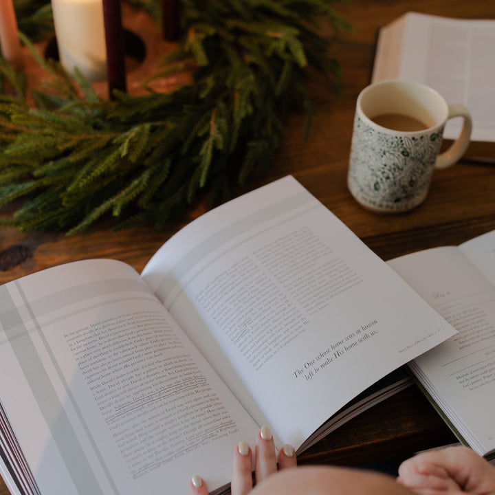 The Awakening Wonder study open on a wooden table next to some greenery and a coffee cup