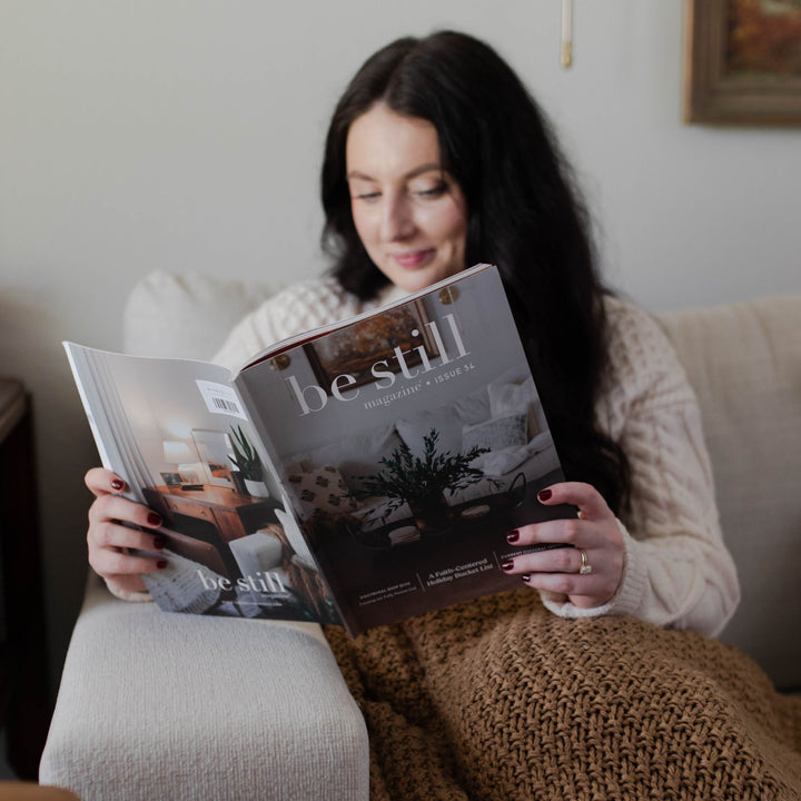 Woman reading Be Still Christian magazine