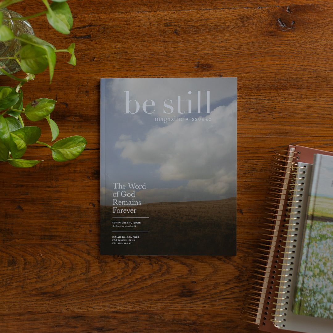 Be Still Issue 40 Magazine Cover on a wooden table near some greenery