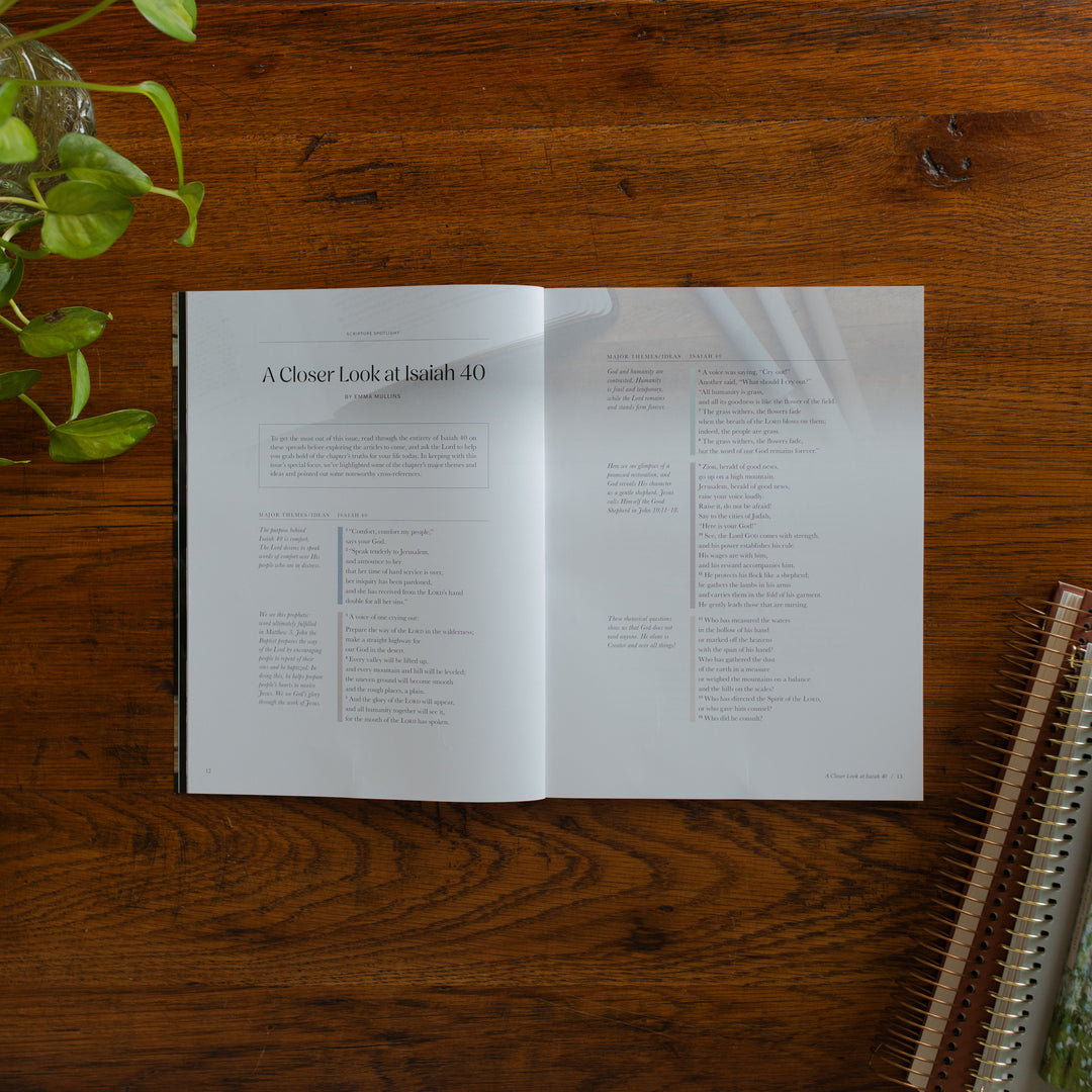 Be Still Issue 40 Magazine opened to the closer look at Isaiah 40 page on a wooden table near some greenery