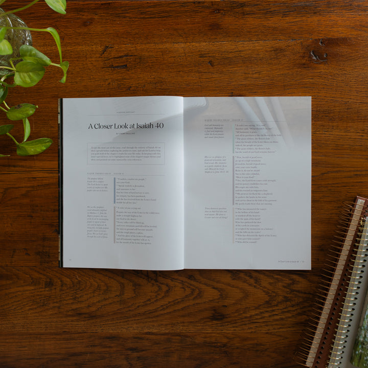 Be Still Issue 40 Magazine opened to the closer look at Isaiah 40 page on a wooden table near some greenery