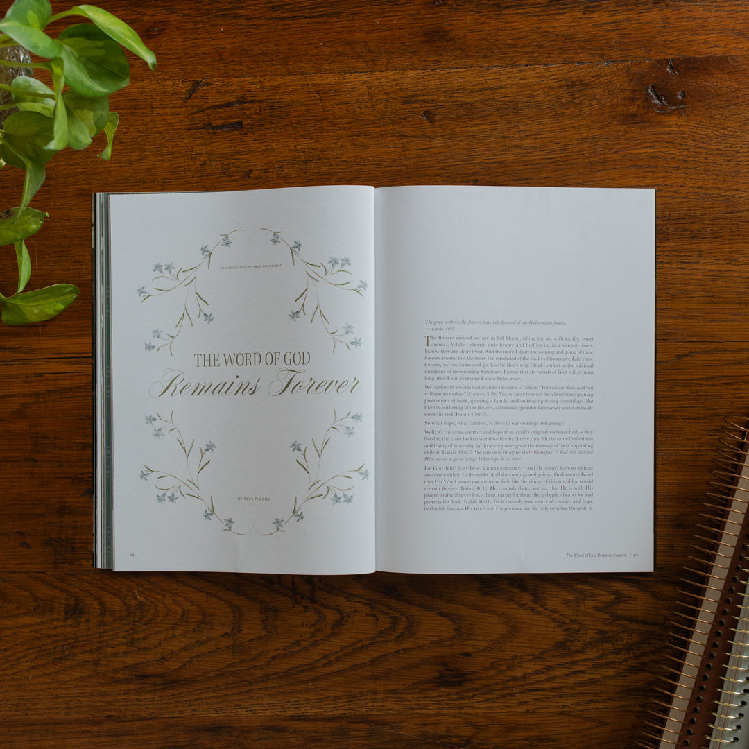 Be Still Issue 40 Magazine opened to the The Word of God remains forever page on a wooden table near some greenery