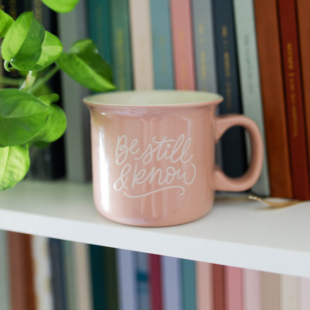 Christian Be Still mug on bookshelf