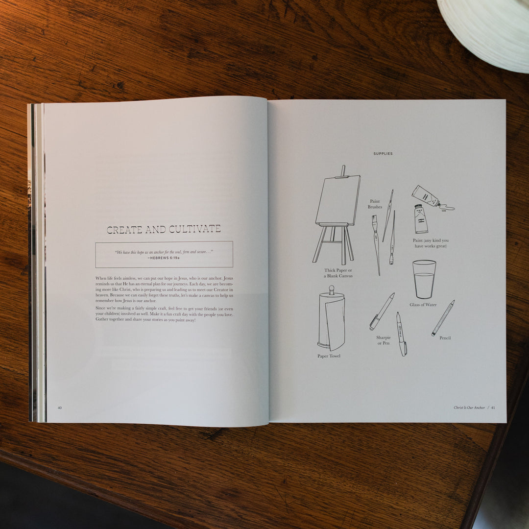 Be Still Issue 37 Magazine opened to the create and cultivate page on a brown wooden table next to a white potted plant