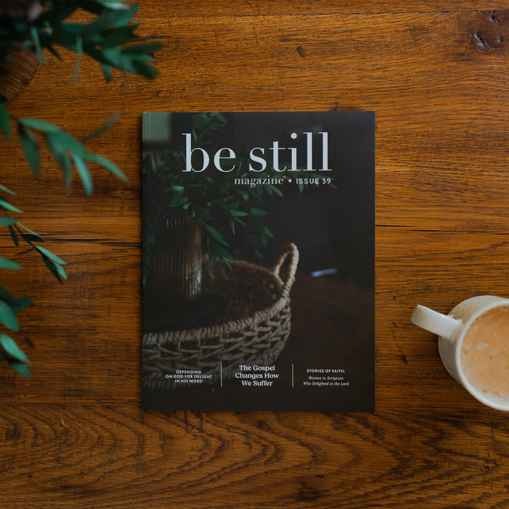 Be Still Magazine Issue 39 cover on a wooden table next to a coffee cup