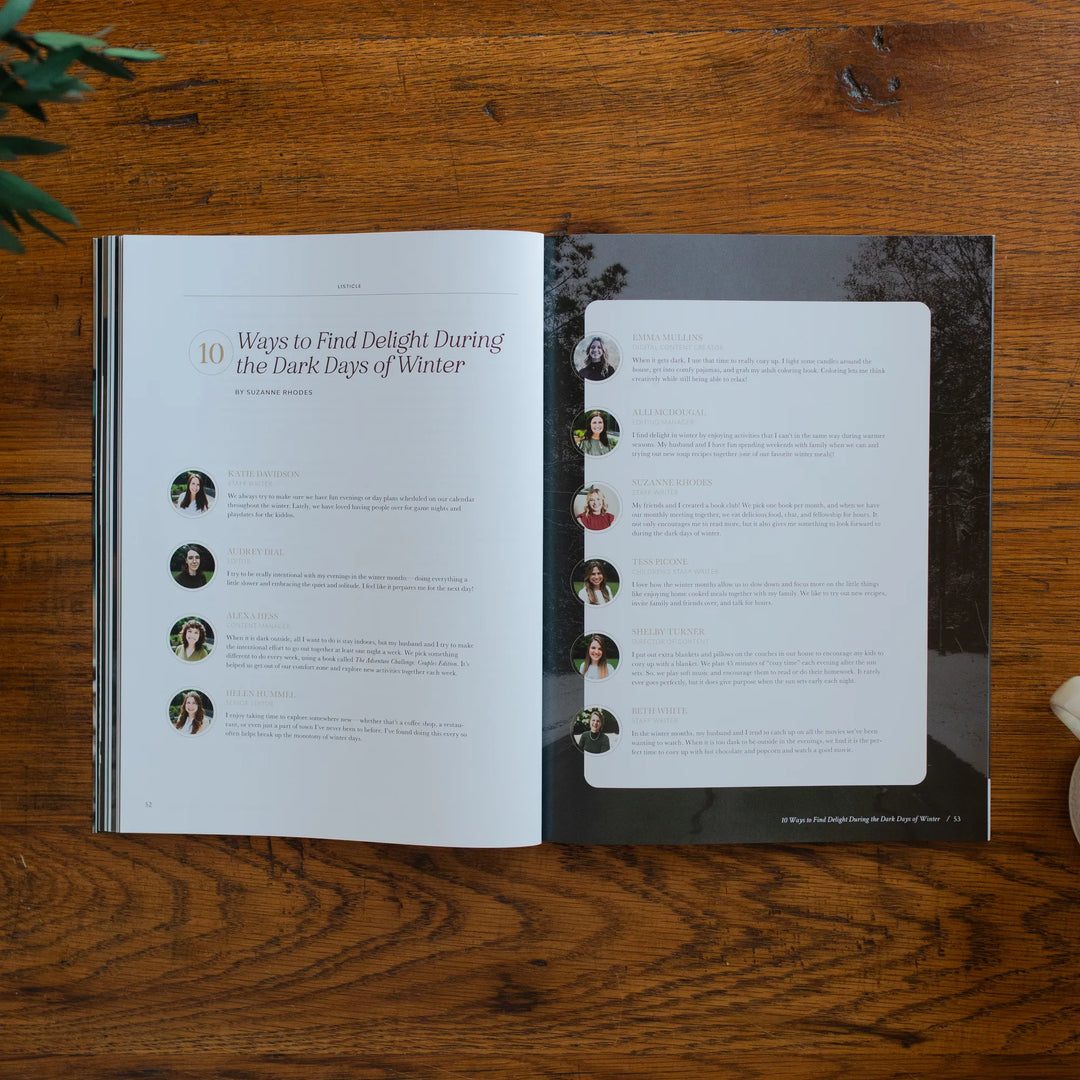 Be Still Magazine Issue 39 opened to the ways to find delight during the dark days of winter page on a wooden table next to a coffee cup