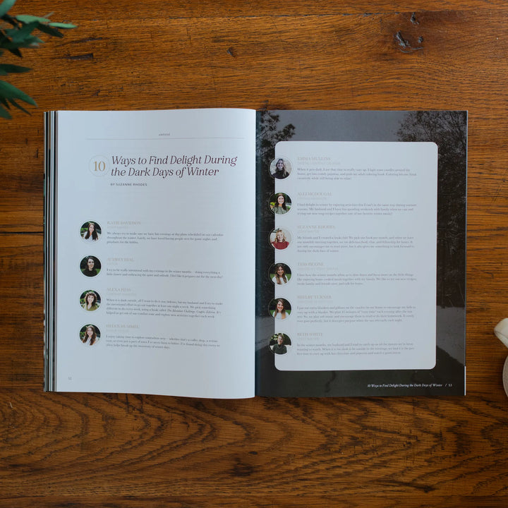 Be Still Magazine Issue 39 opened to the ways to find delight during the dark days of winter page on a wooden table next to a coffee cup