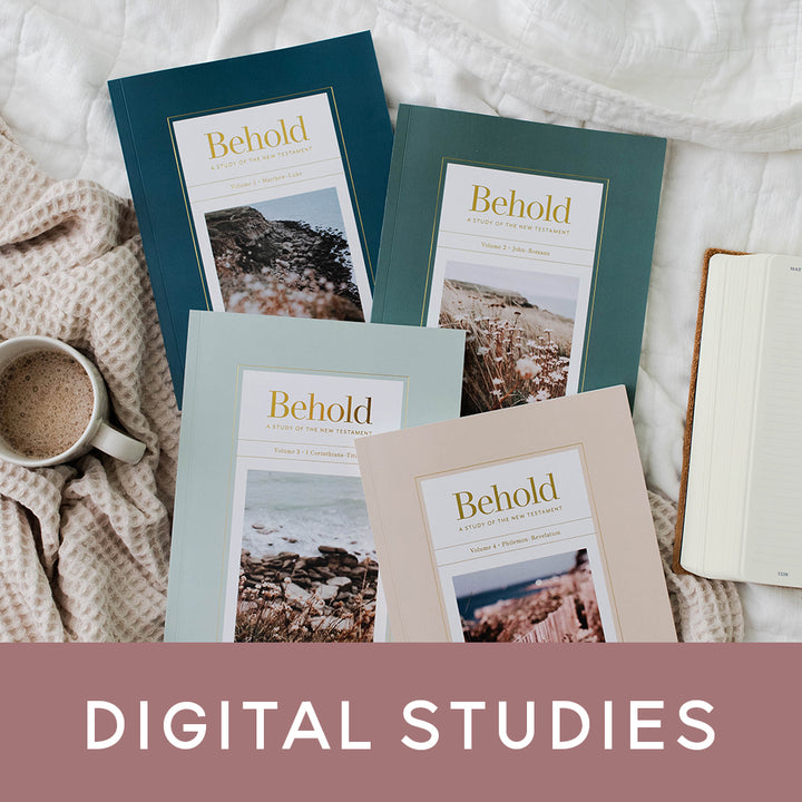 Behold Bible studies laying on a bed next to a coffee mug and Digital Studies banner on the photo.