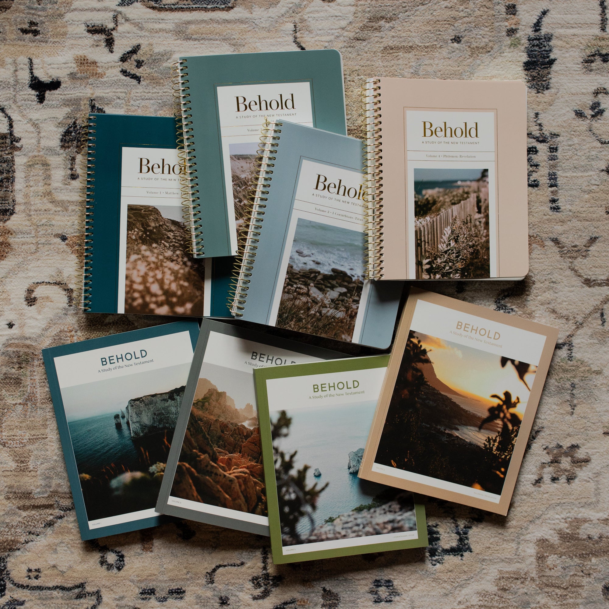 Behold Spiral study and the Behold men's version scattered on a rug