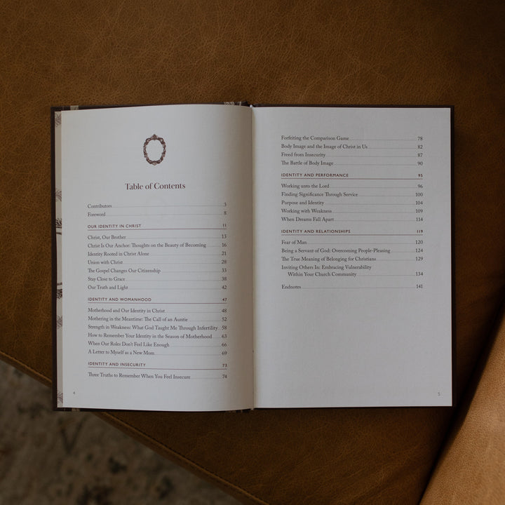 The Beloved How Belonging to Jesus Secures your Identity book opened to the table of contents page resting on a brown leather couch