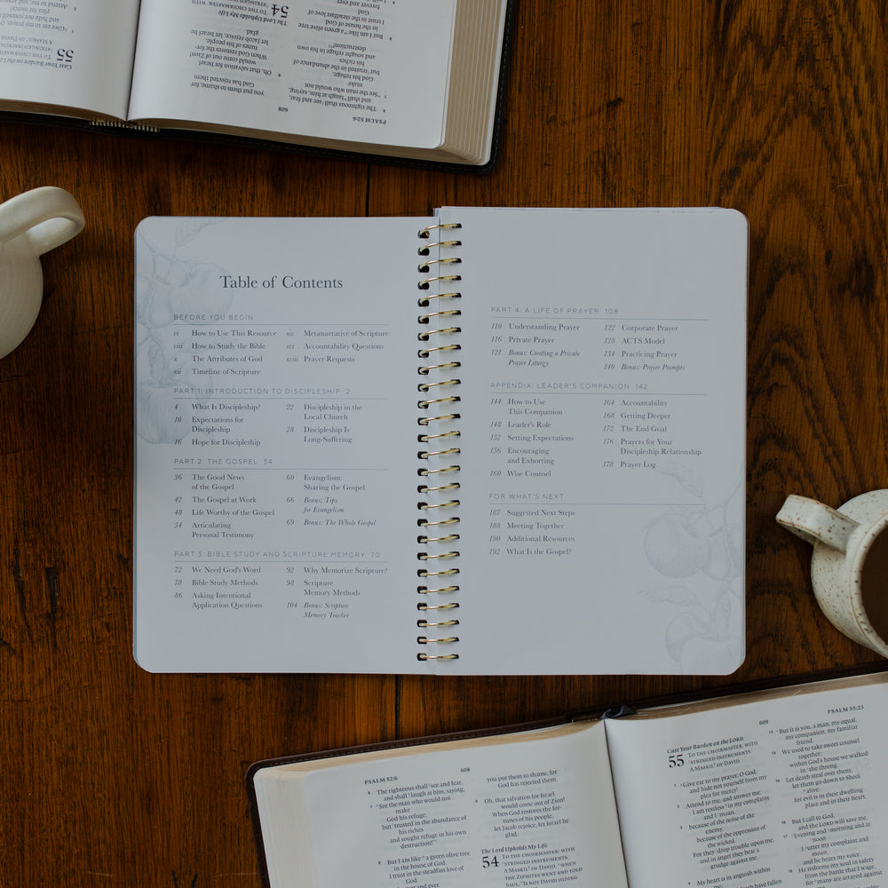 The Better Together Discipleship Guide opened to the table of contents page on a wooden surface