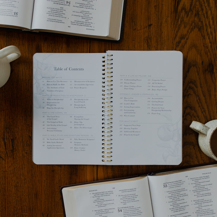 The Better Together Discipleship Guide opened to the table of contents page on a wooden surface