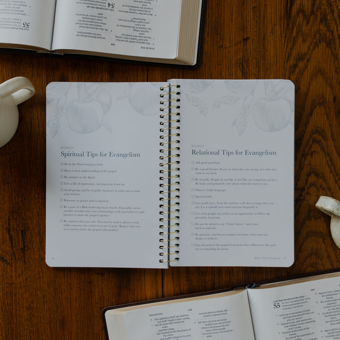 The Better Together Discipleship Guide opened to the tips for Evangelism page on a wooden surface