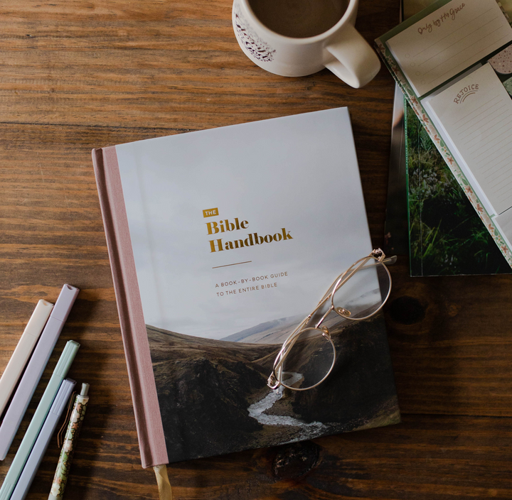 Bible Handbook on table with highlighters and christian sticky notes