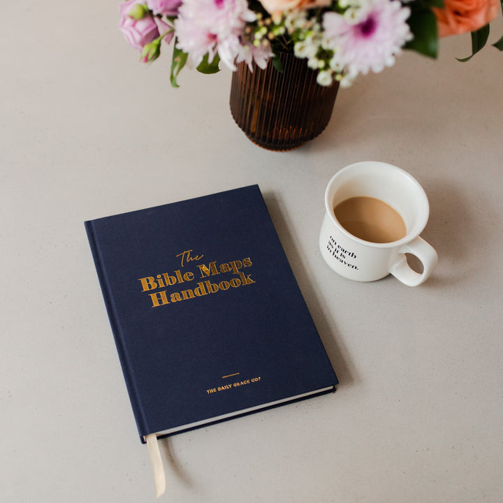 Handbook closed on table next to cup of coffee