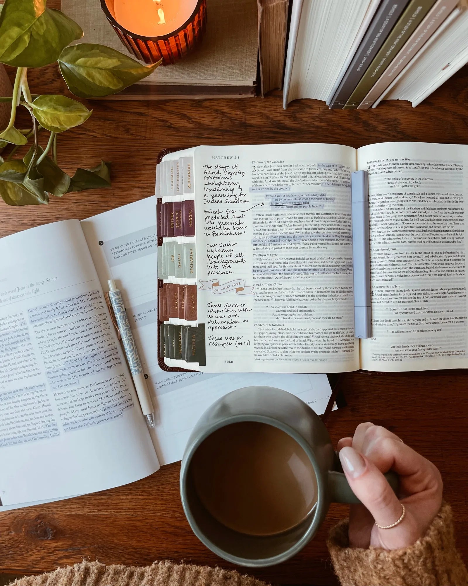 Bible opened with a highlighter resting in the middle on an opened bible study