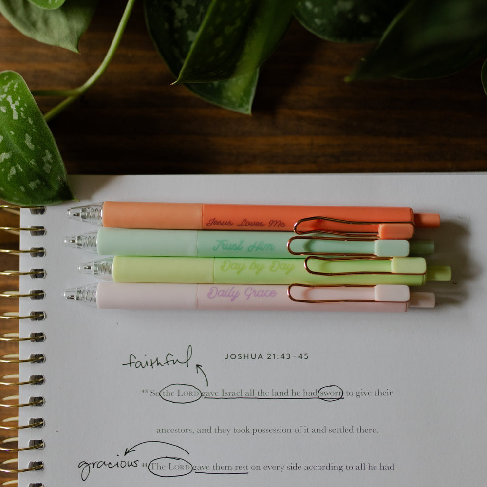 Bright Reminders Pen Set with words on pens visible at the top of a Bible study laying on a table