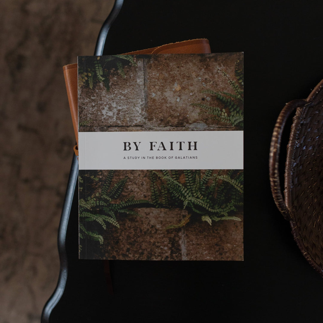 Cover of By Faith Bible study for men on the book of Galatians sitting on a table