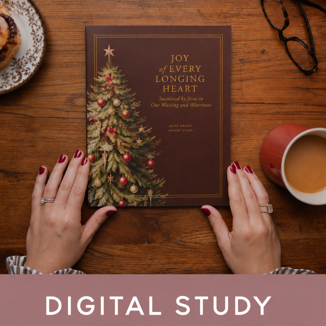 A digital study book titled 'Joy of Every Longing Heart' is held by two hands over a wooden table, surrounded by holiday greenery, a pastry, eyeglasses, and a cup of tea. A pink banner at the bottom reads 'DIGITAL STUDY'.