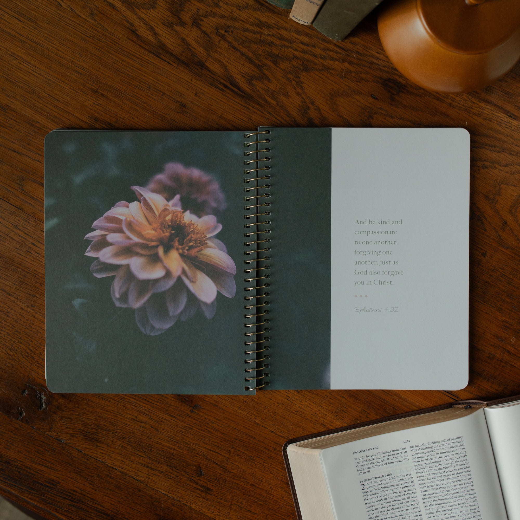 The Chosen study opened to a quote from Ephesians with a flower on the other page resting on a wooden table near an open bible