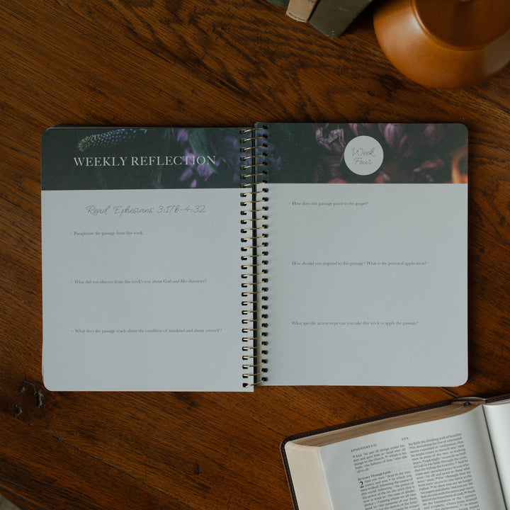 The Chosen Ephesians study opened to the weekly reflections page on a wooden table and an open bible