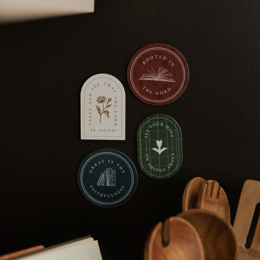 4 of the Classic Reminders Magnets on a black fridge