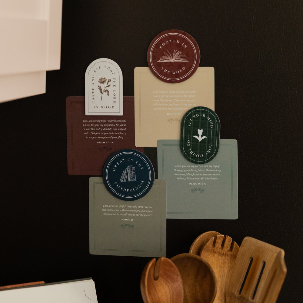 4 of the Classic Reminders Magnets on a black fridge holding up multiple verse cards