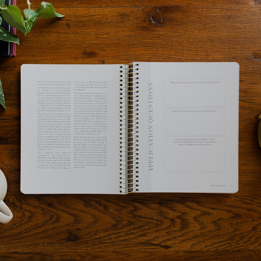Clinging to the Cross Spiral study opened to the applications and questions page on a wooden table