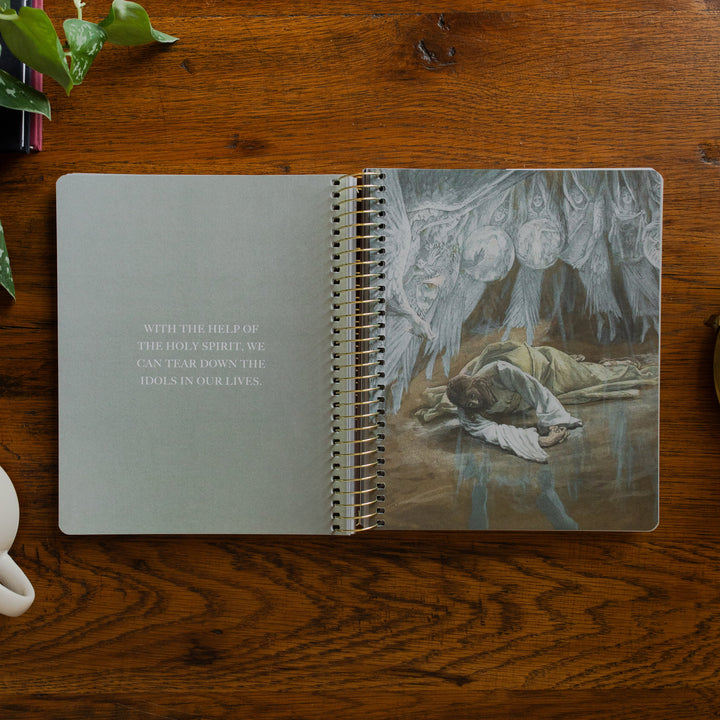 Clinging to the Cross Spiral study opened to the devotional page on a wooden table