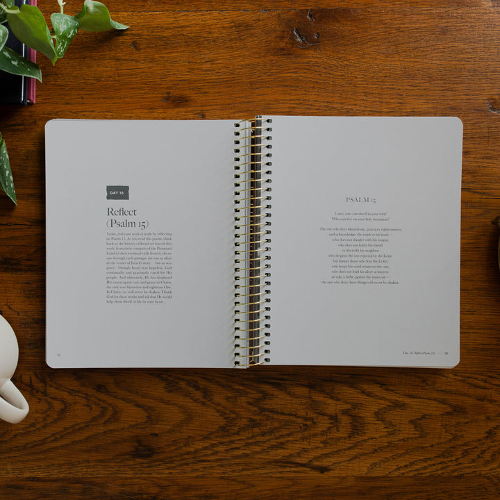 Clinging to the Cross Spiral study opened to the reflect(Psalm 15) page on a wooden table