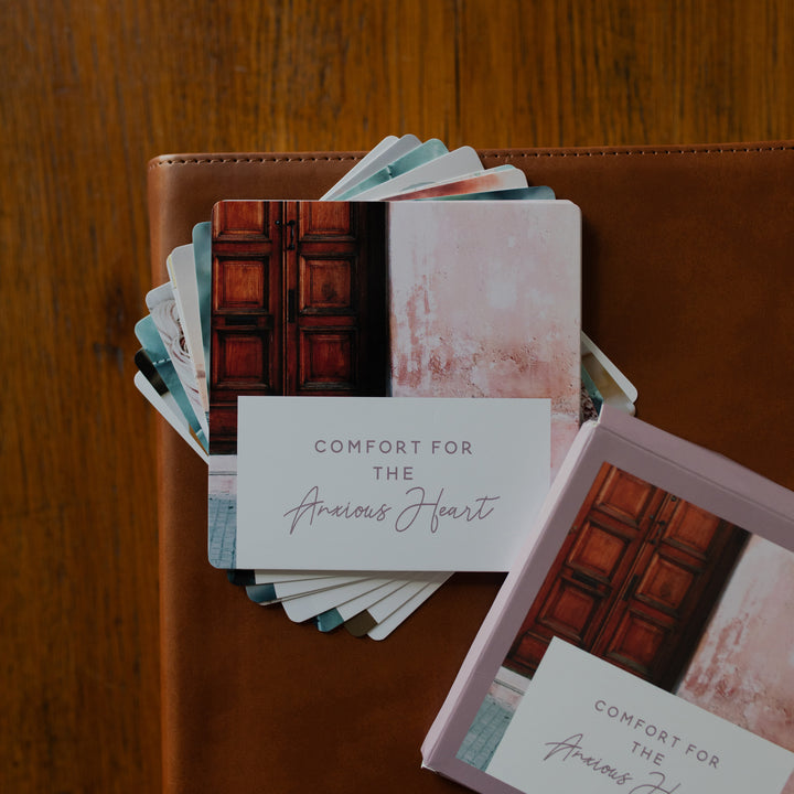Comfort for the Anxious Heart Verse Cards stacked on a leather bible