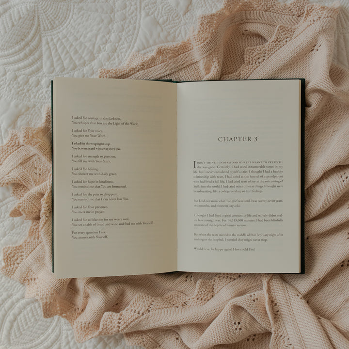 The Daily Grace Hardcover book opened to chapter 3 page on some white sheets