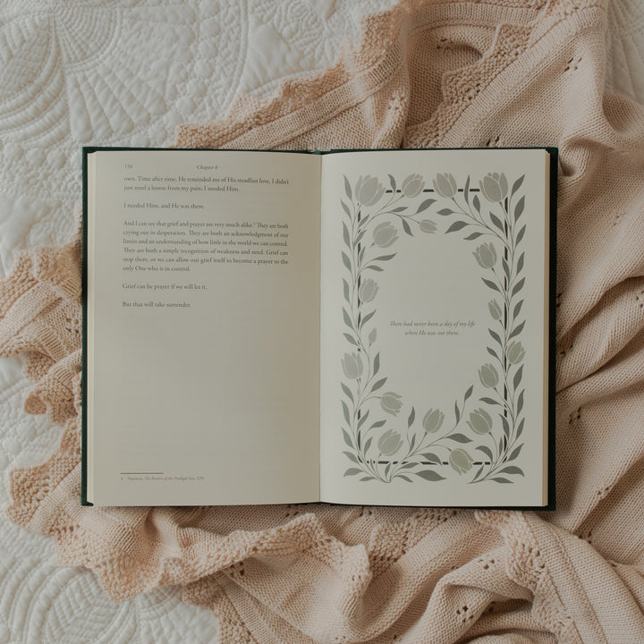 The Daily Grace Hardcover book opened to the chapter 8 ending page on some white sheets