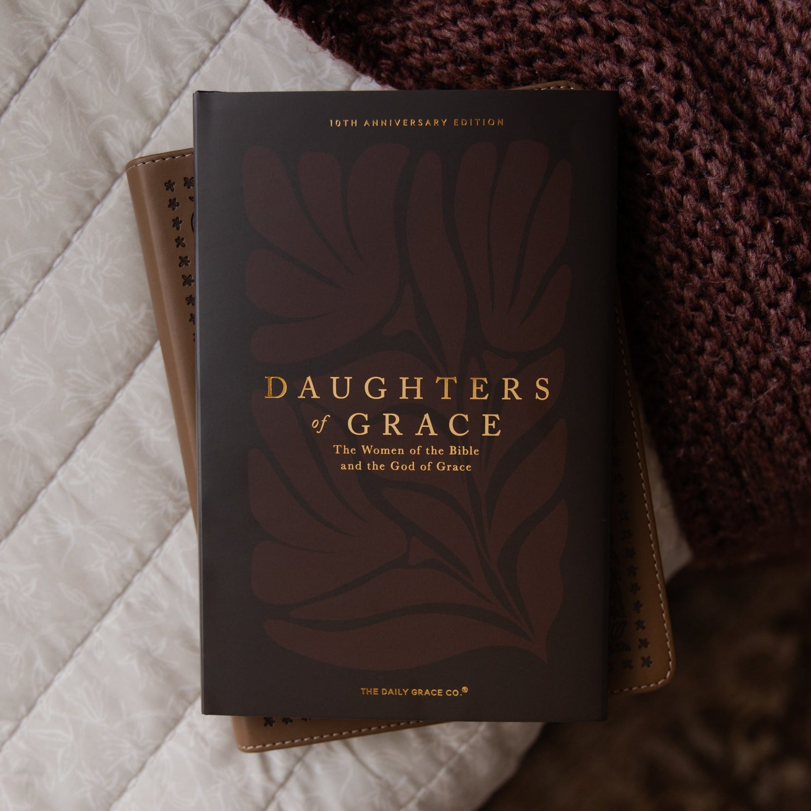 Book titled 'Daughters of Grace' on a textured surface
